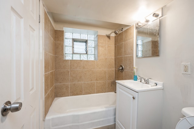 full bathroom with vanity, toilet, and tiled shower / bath