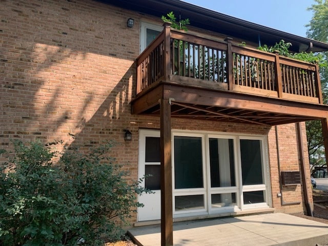 rear view of property featuring a balcony