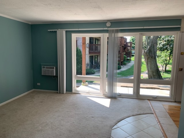 entryway with a wall mounted AC, light carpet, and a textured ceiling