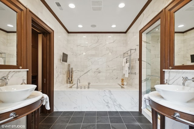 bathroom with a relaxing tiled tub, tile walls, and vanity