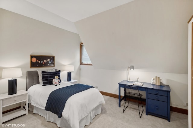 bedroom with vaulted ceiling and light carpet