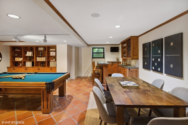 game room featuring pool table, bar, rail lighting, light tile patterned floors, and ornamental molding