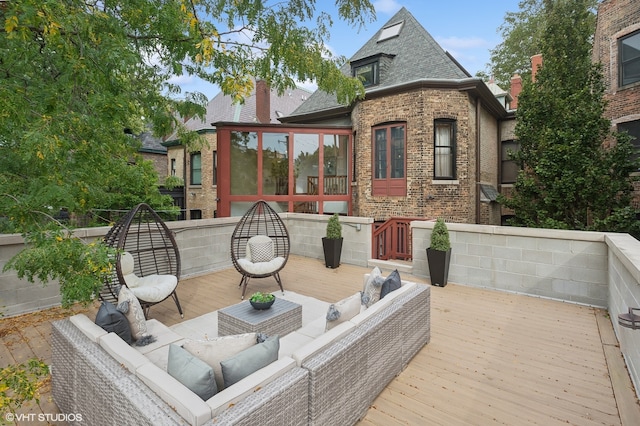 wooden terrace featuring a sunroom and an outdoor hangout area