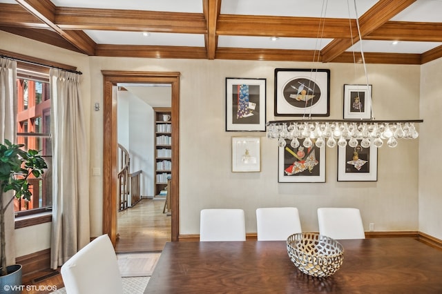 dining area featuring wood-type flooring, coffered ceiling, and beamed ceiling