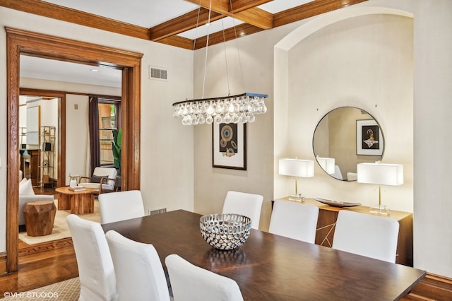 dining area featuring ornamental molding, wood-type flooring, beamed ceiling, and coffered ceiling