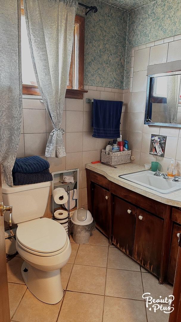 bathroom featuring tile patterned flooring, vanity, and toilet