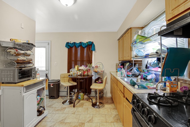 kitchen with light tile patterned flooring, black range with gas stovetop, and light brown cabinets