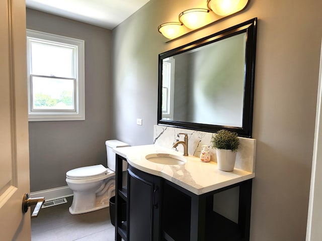 bathroom with vanity, backsplash, tile patterned flooring, and toilet