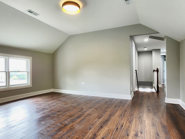 additional living space with lofted ceiling and dark wood-type flooring