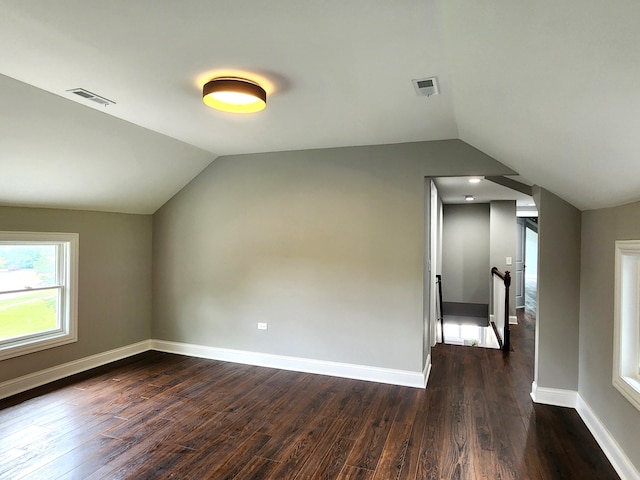 bonus room featuring wood-type flooring and vaulted ceiling