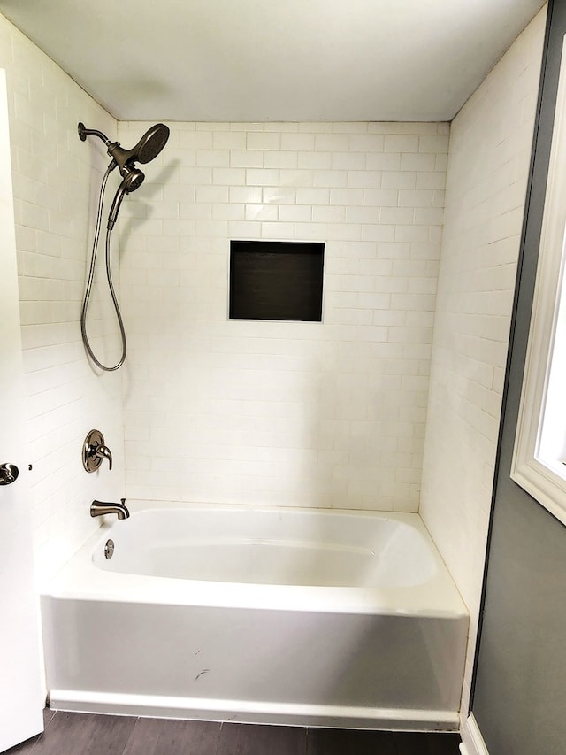 bathroom featuring tiled shower / bath combo and hardwood / wood-style floors