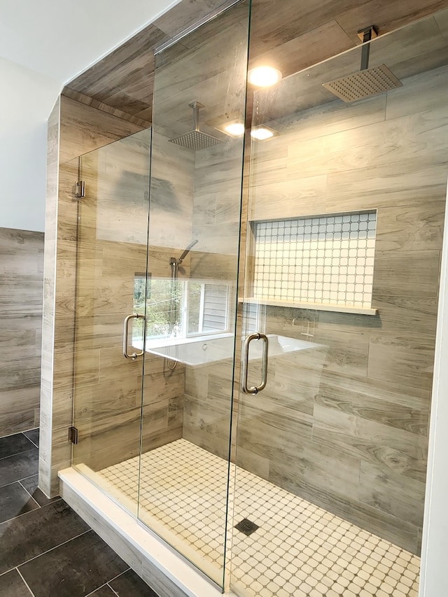 bathroom with walk in shower and tile patterned floors