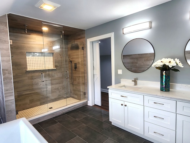 bathroom featuring vanity, tile patterned flooring, and walk in shower