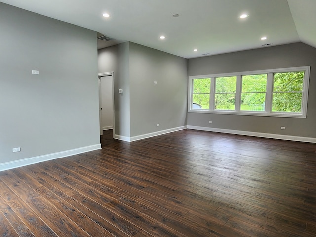 unfurnished room with wood-type flooring and vaulted ceiling