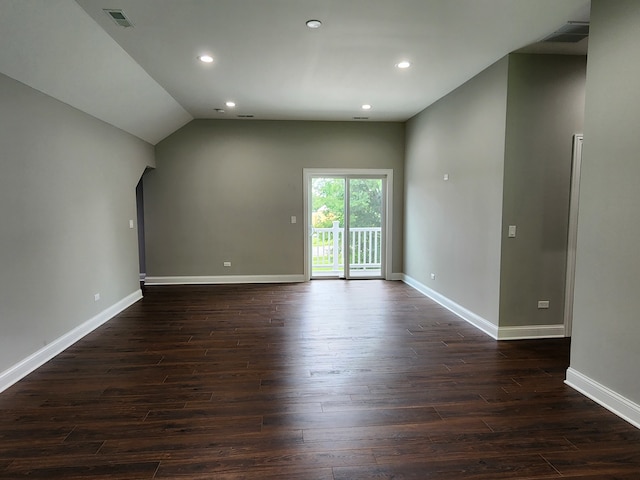 empty room featuring dark hardwood / wood-style floors and vaulted ceiling