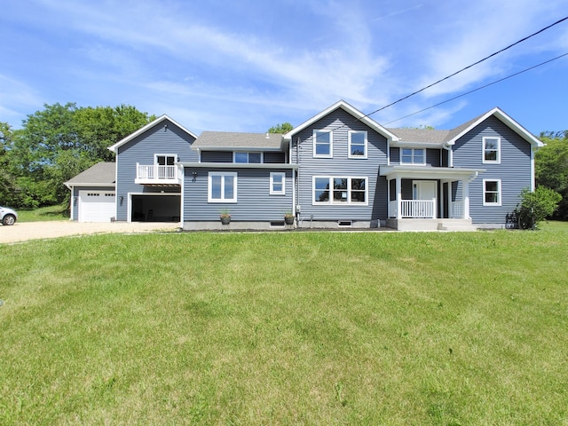 view of front facade with covered porch, a garage, and a front yard