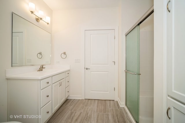 bathroom featuring vanity, tile patterned floors, and walk in shower