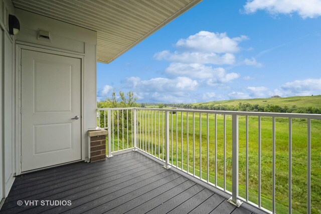 wooden deck featuring a lawn