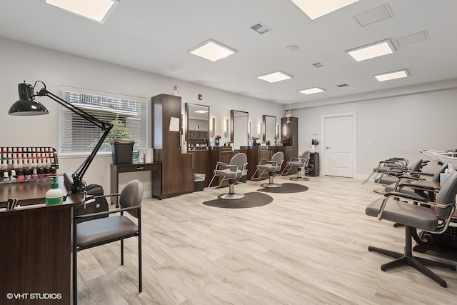 exercise room with light wood-type flooring