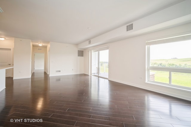 spare room with hardwood / wood-style flooring and a healthy amount of sunlight