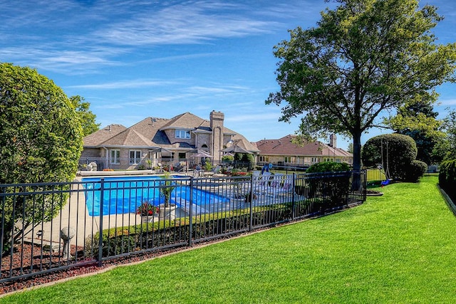 pool with a yard and fence