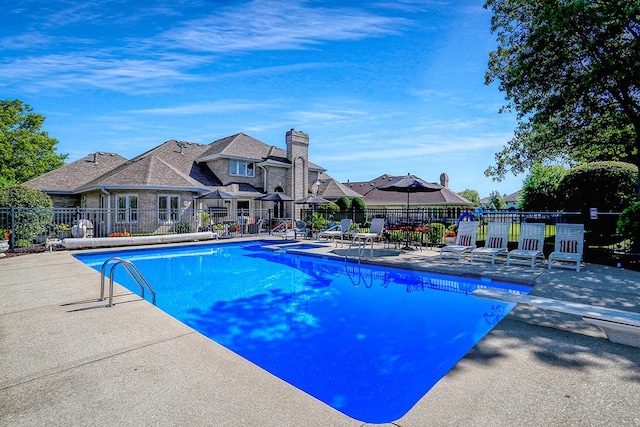 pool featuring a patio and fence