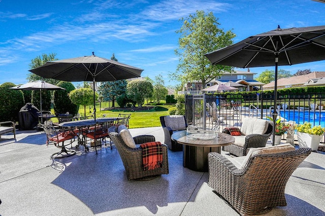 view of patio with a fenced in pool and outdoor dining area