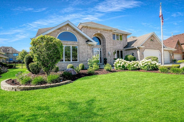 view of front of home featuring a garage, brick siding, fence, and a front lawn