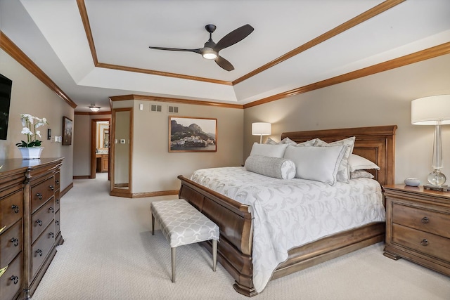 bedroom featuring crown molding, a raised ceiling, light colored carpet, ceiling fan, and baseboards