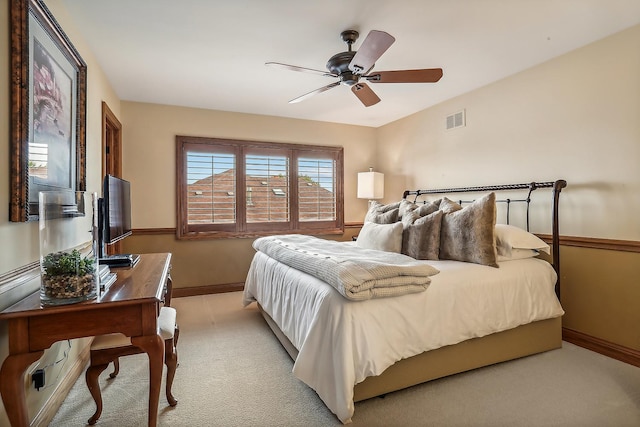 bedroom with light carpet, a ceiling fan, visible vents, and baseboards