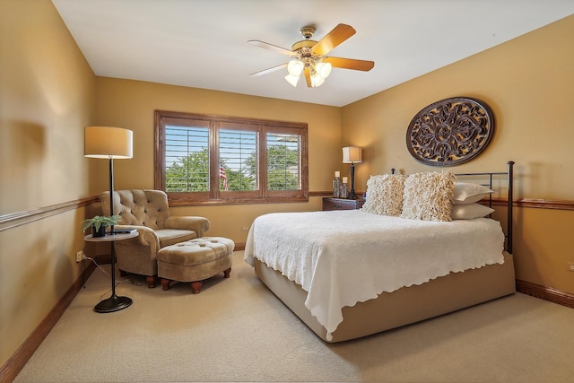 carpeted bedroom featuring a ceiling fan and baseboards