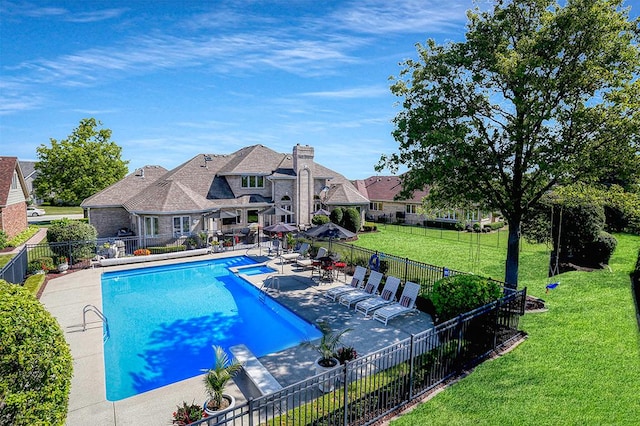 pool featuring a patio, a lawn, and fence