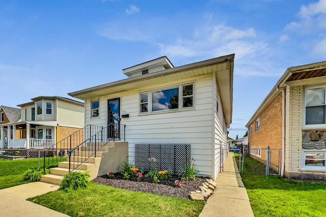 view of front of home featuring a gate, fence, and a front lawn