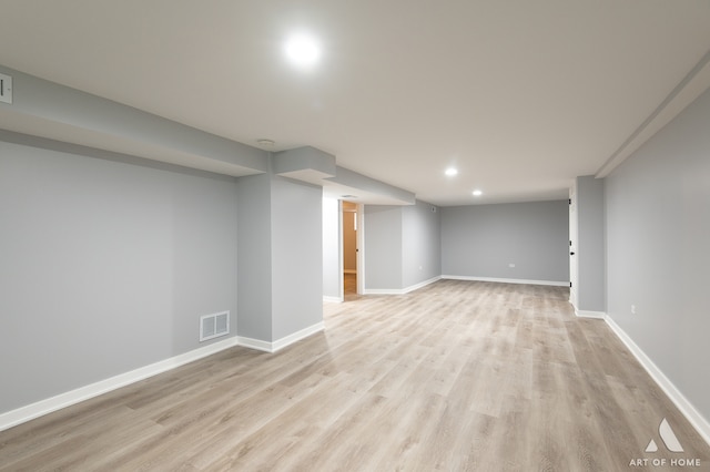 basement with light hardwood / wood-style floors