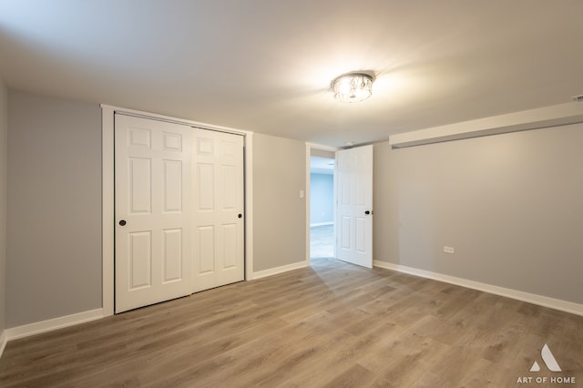 unfurnished bedroom with a closet and wood-type flooring