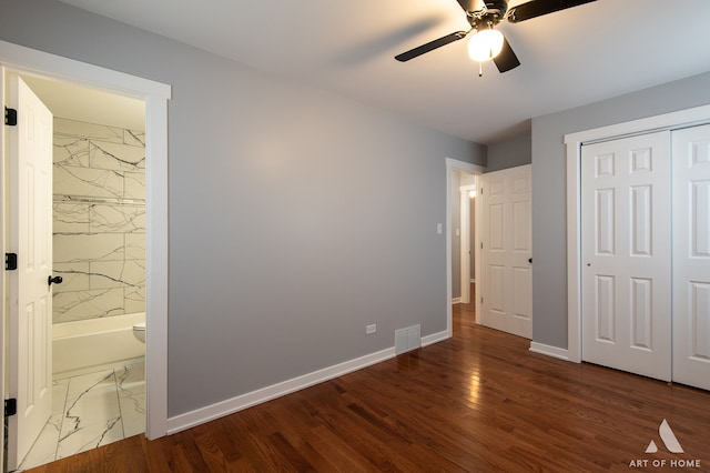 unfurnished bedroom with ceiling fan, hardwood / wood-style flooring, connected bathroom, and a closet