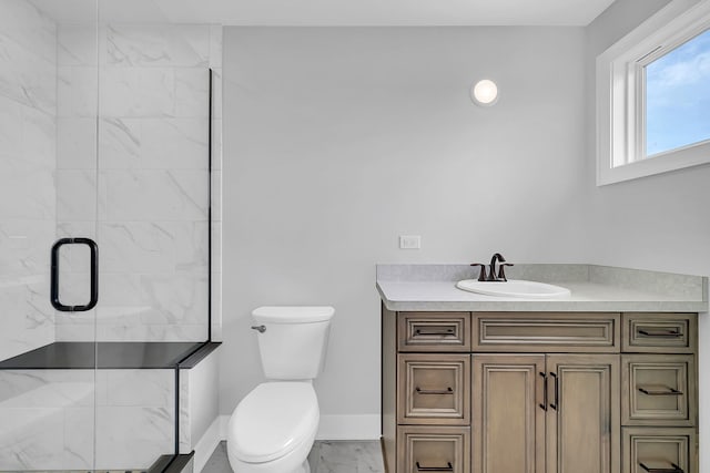 full bathroom with marble finish floor, toilet, a shower stall, vanity, and baseboards