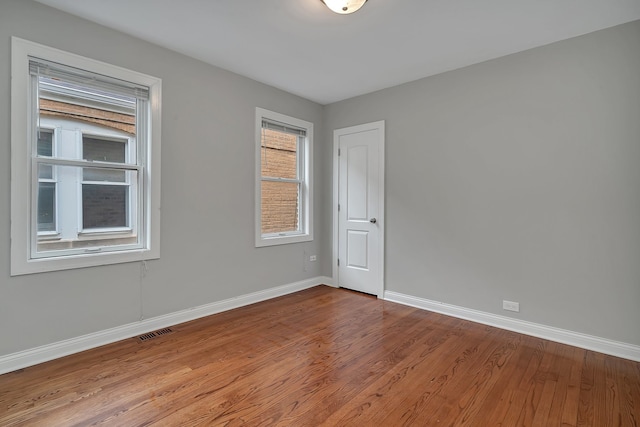 unfurnished room with hardwood / wood-style floors