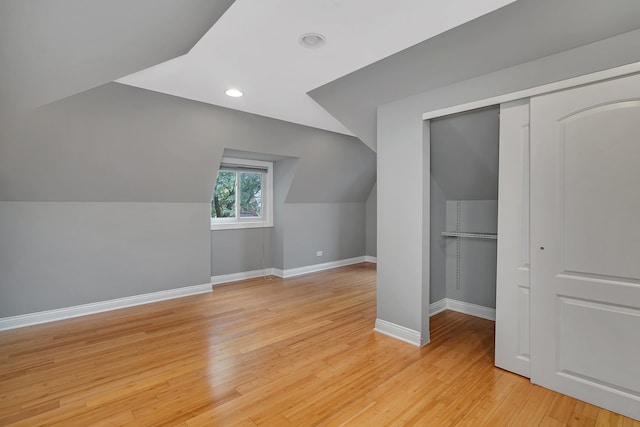 bonus room with light hardwood / wood-style flooring and lofted ceiling