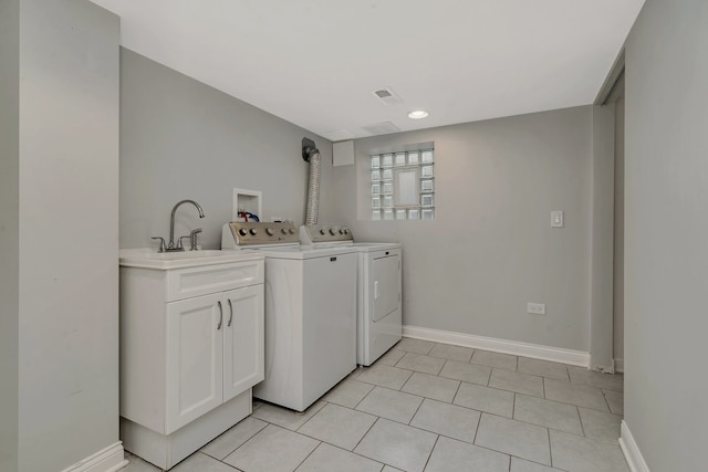 washroom featuring sink, washing machine and clothes dryer, and light tile patterned floors