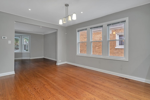 unfurnished room with hardwood / wood-style floors