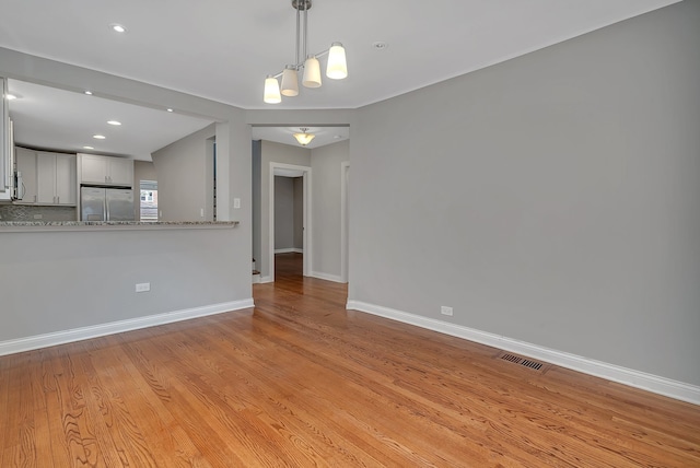 unfurnished living room with light hardwood / wood-style floors