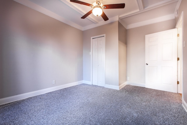 unfurnished bedroom with a closet, carpet, crown molding, and ceiling fan