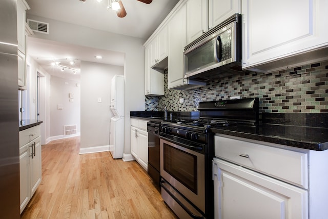 kitchen with tasteful backsplash, appliances with stainless steel finishes, light hardwood / wood-style floors, ceiling fan, and white cabinets