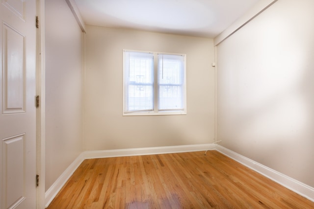 empty room with light hardwood / wood-style flooring