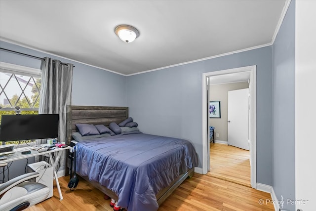 bedroom featuring light hardwood / wood-style floors and crown molding