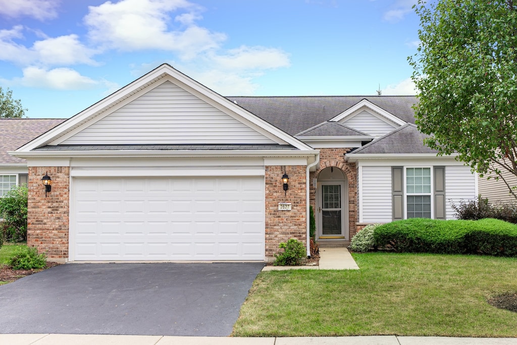 single story home with a garage and a front yard