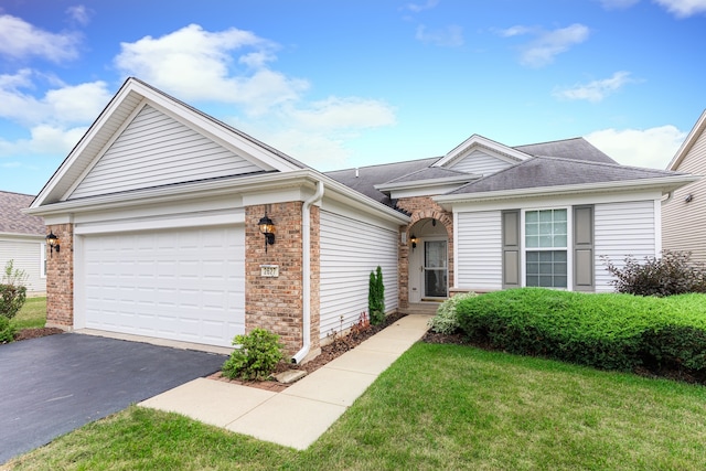 view of front facade with a front yard and a garage