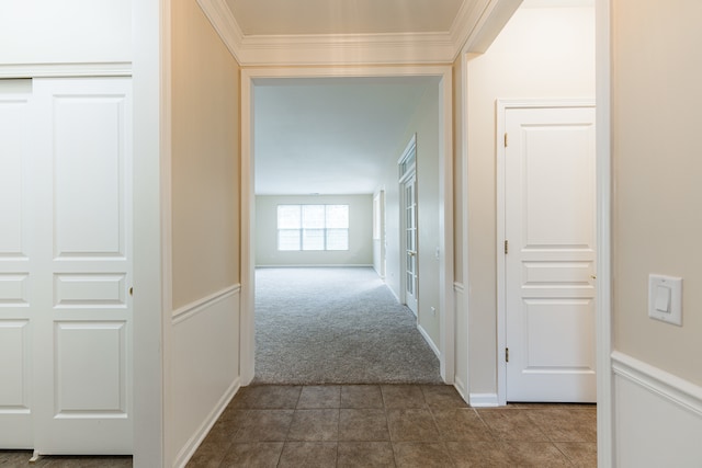 hall featuring ornamental molding and carpet flooring