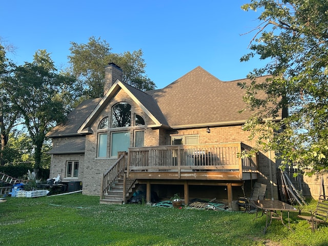 rear view of property with a yard and a deck